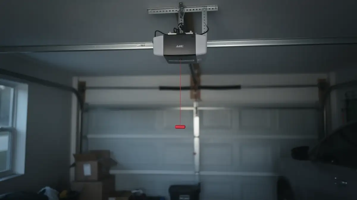 The garage door opener hangs from the ceiling with a red emergency release cord.